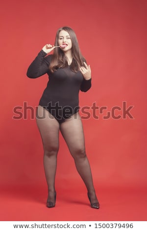 Stock fotó: Happy Woman In Bodysuit Holding Candy