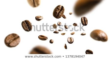[[stock_photo]]: Falling Coffee Bean On Background Of Heap Of Roasted Beans