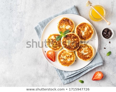 ストックフォト: Delicious Cottage Cheese Pancakes Or Syrniki With Fresh Blueberry In Cast Iron Pan On Dark Wooden Ru