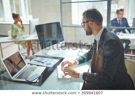 Stok fotoğraf: Businessman In The Office Working On A Laptop