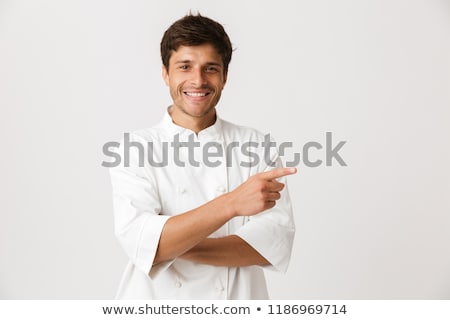 Stock photo: Young Chef Man Standing Isolated Over White Wall Background Holding Crockery