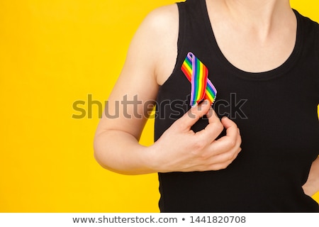 Foto d'archivio: Woman With Gay Pride Awareness Ribbon On Her Chest