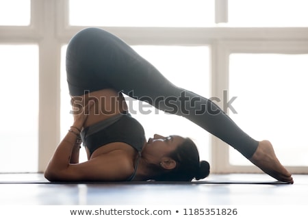 Stok fotoğraf: Woman Practicing Plow Pose On Yoga Mat