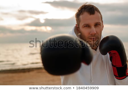 Foto stock: Sports Man Boxer Outdoors On The Beach Boxing In Gloves