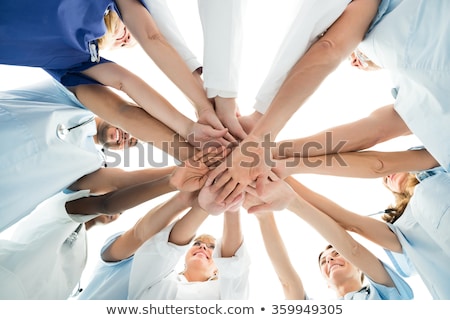 Zdjęcia stock: Directly Below Shot Of Doctor Stacking Hands Together