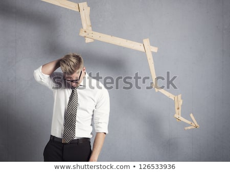 Stock fotó: Upset Businessman In Front Of Descending Graph