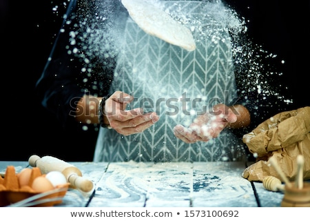 Foto stock: The Man Chef Cooks Throws The Dough Flying Freezing In Motion