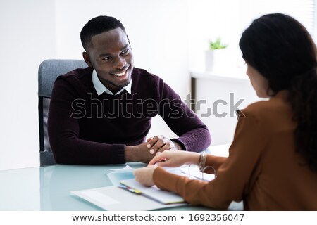 Stok fotoğraf: Financial Advisor Discussing Invoice With Her Client