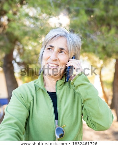 Сток-фото: Happy Senior Woman With Smartphone At Autumn Park