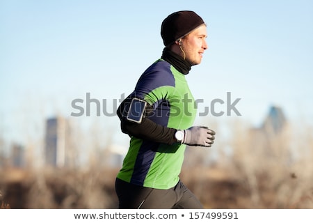 Running Man Jogging In Autumn To Music On Phone Stock foto © Maridav