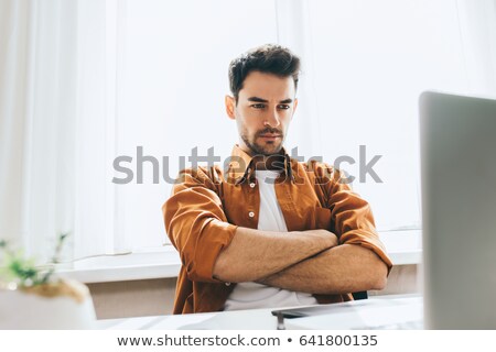 Stock fotó: Young Businessman Thinking With Arms Crossed