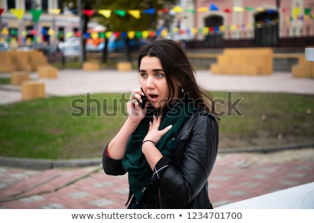 Сток-фото: Surprised Businesswoman Walking Down The Street While Talking On