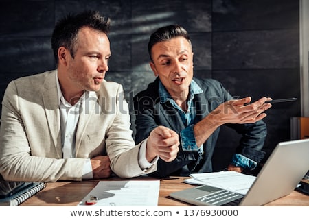Imagine de stoc: Businessman Discussing With Colleague Over Laptop