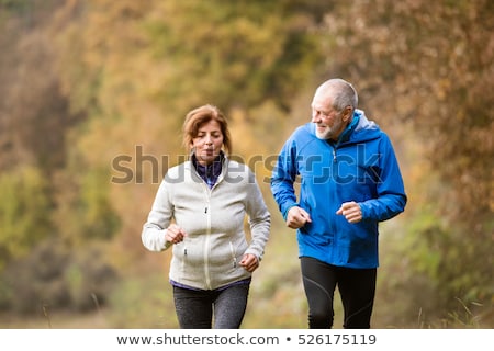 Stock photo: Senior Couple Running In The Park