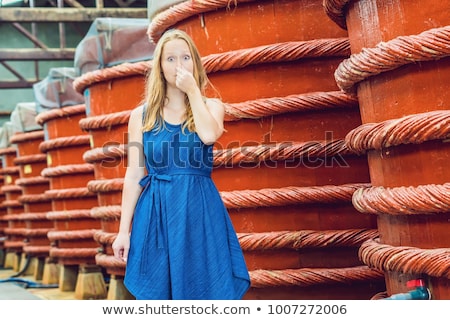 Foto stock: The Woman Shows How Stinks Fish Sauce On Phu Quoc Vietnam