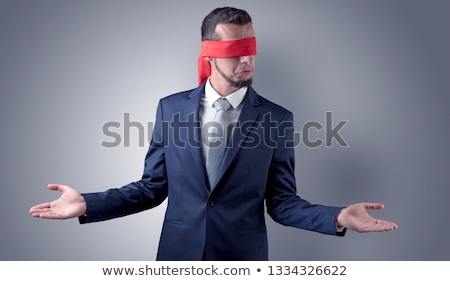 Foto stock: Covered Eye Businessman In Front Of A Wall