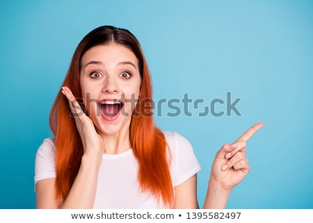 Foto stock: Fashionable Woman Surprised Looking Up And Touching Face