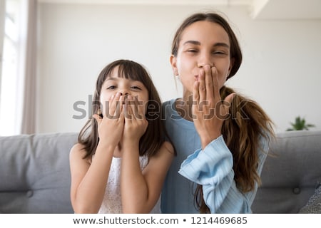 Stock photo: Portrait Of A Beauty Sending Kiss To The Camera The Girl Has Long Beautiful Dark Hair Pink Studio