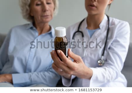 Stock foto: Woman Pharmacist Reading Recipe