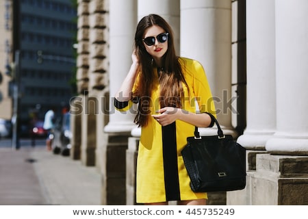 Stock foto: A Woman In A Dress On The Street With Glasses And A Leather Belt