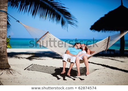 Stok fotoğraf: Attractive Couple Relaxing On A Tropical Beach