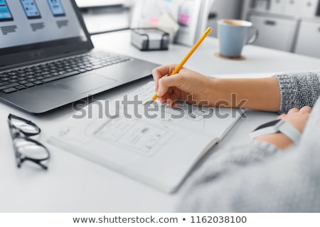 Stock photo: Ui Designer With User Interface Sketch In Notebook