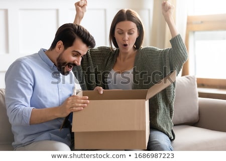 Foto d'archivio: Happy Couple With Open Parcel Box At Home
