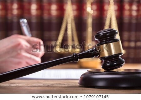 Foto stock: Close Up Of Hand Male Lawyer Working With Scales Of Justice Gav