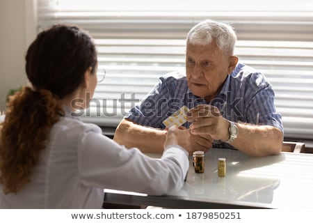 Stok fotoğraf: Doctor Explaining And Giving A Consultation To A Patient Medical