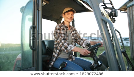 Zdjęcia stock: Farmer Woman Driving A Tractor