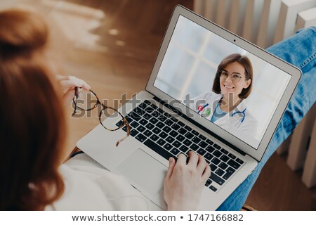 Foto stock: Unrecognizable Woman Has Video Chat With Experienced Doctor On Laptop Computer Gets Consultancy Duri