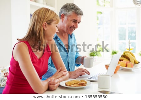 Stock fotó: Man Having Breakfast Whilst Using Laptop