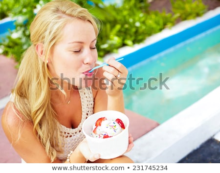 ストックフォト: Beautiful Blonde Woman Holding A Tub Of Ice Cream