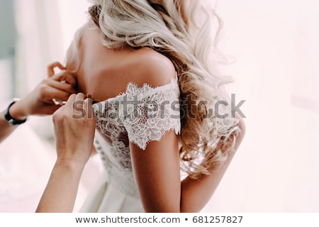 Stockfoto: Hands Helping To Put On A Wedding Dress