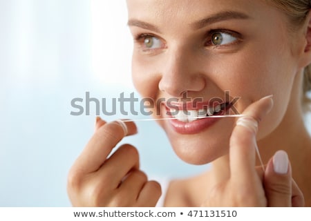 Stock fotó: Happy Young Woman With Dental Floss Cleaning Teeth