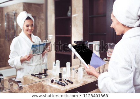 Foto stock: Side View Of Woman In Bathrobe Holding Book