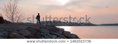 Foto stock: Beautiful Girl On Rocky Shore