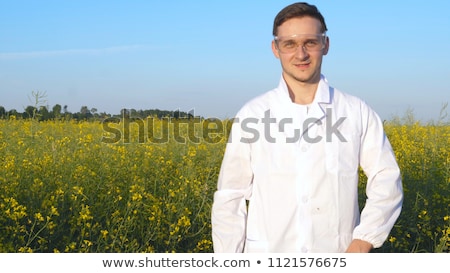 Сток-фото: Agriculture Farmer Examining Wheat Field With Rapeseed Plants I