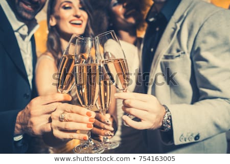 Foto stock: Men And Women Celebrating Party While Clinking Glasses