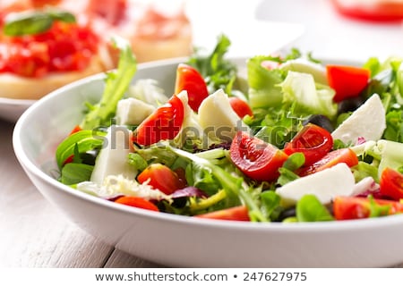 Foto stock: Fresh Cherry Tomato Mozzarella Salad With Green Lettuce Mix