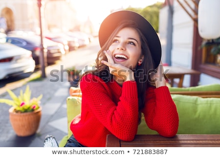 Stock photo: Close Up Of A Happy Girl In Hat Sitting At The Cafe Table