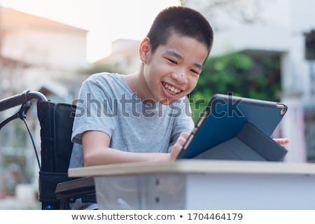 Foto stock: The Disabled Student Studying At Home On Wheelchair