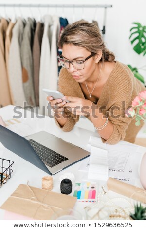 Zdjęcia stock: Pretty Young Casual Shop Assistant Of Modern Boutique Bending Over Workplace
