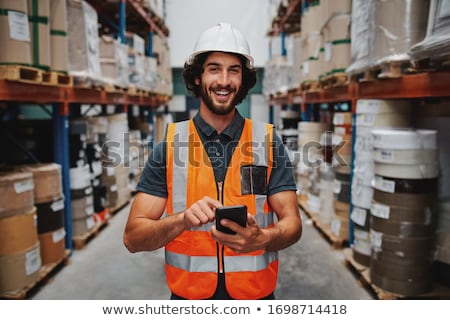 Stockfoto: Confident Young Male Employee With Mobile Gadget Standing In Modern Cafe