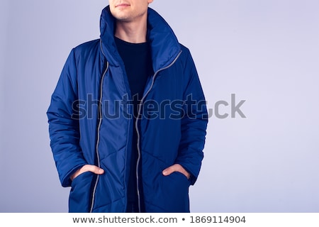 Zdjęcia stock: Portrait Of Smiling Bearded Male Guy Dressed In Warm Clothes Shakes Tree Covered With Snow Has Ple