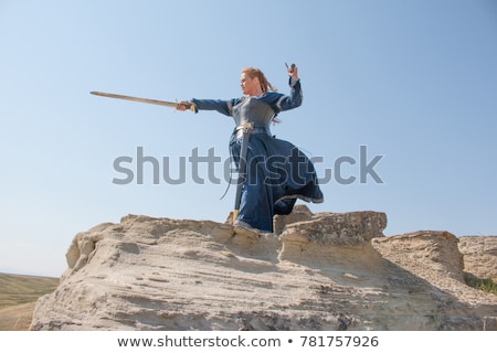 Stockfoto: Woman In The Medieval Costume Holding A Sword