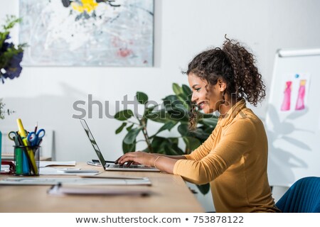 Foto stock: Side View Of Happy Young Woman Using Laptop