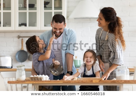 Stock fotó: Mother With Kids Bake Together At A Kitchen