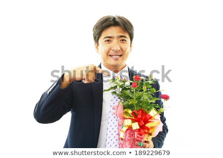 Asian Businessman Holding A Bouquet Of Flowers Stock foto © sunabesyou