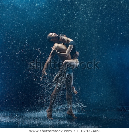 Stockfoto: The Young Beautiful Modern Dancer Dancing Under Water Drops